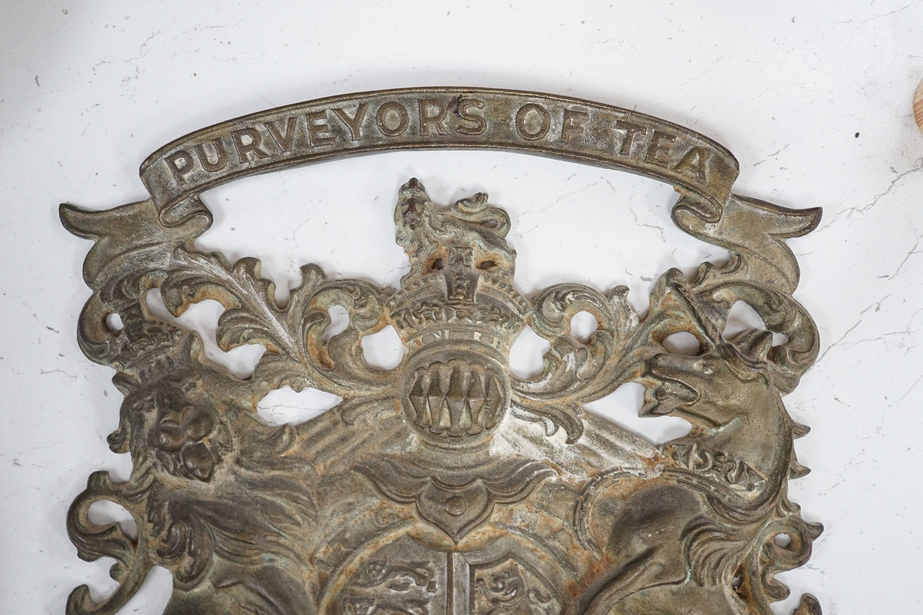 A 'Purveyors of Tea' armorial brass plaque, height 39cm